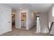 Upstairs hallway with laundry room and carpeted floor at 615 R L Stowe Rd, Belmont, NC 28012