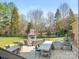 Outdoor kitchen and fireplace with seating, offering a perfect backyard for entertaining at 620 Briar Patch Ter, Waxhaw, NC 28173