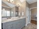 Spacious bathroom featuring double vanity with marble countertop and decorative lighting at 620 Briar Patch Ter, Waxhaw, NC 28173