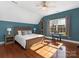 Bedroom with abundant natural light features wood floors, a bed, and a keyboard near the window at 620 Briar Patch Ter, Waxhaw, NC 28173