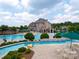 Luxury community pool with spacious deck, lazy river, lush landscaping, and clubhouse at 620 Briar Patch Ter, Waxhaw, NC 28173