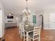 Open-concept dining room with hardwood floors and decorative chandelier at 620 Briar Patch Ter, Waxhaw, NC 28173