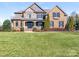 Beautiful brick home featuring a manicured lawn, a blend of brick and stone, and a covered porch entry at 620 Briar Patch Ter, Waxhaw, NC 28173