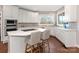 Bright kitchen with white cabinets, a quartz countertop island with seating at 620 Briar Patch Ter, Waxhaw, NC 28173