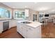 Bright kitchen with quartz countertop island, stainless steel appliances and tile backsplash at 620 Briar Patch Ter, Waxhaw, NC 28173