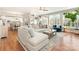 Bright living room with hardwood floors, large windows, and a comfortable sectional sofa with views into kitchen at 620 Briar Patch Ter, Waxhaw, NC 28173