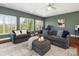 Spacious living room featuring comfortable seating, three large windows, and natural light at 620 Briar Patch Ter, Waxhaw, NC 28173