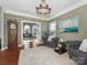 Inviting living room showcasing a classic grandfather clock, comfortable seating, and ample natural light at 620 Briar Patch Ter, Waxhaw, NC 28173