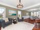 Cozy living room featuring crown molding, a stylish chandelier, and comfortable seating, seamlessly connected to dining area at 620 Briar Patch Ter, Waxhaw, NC 28173