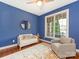 Stylish living room featuring a white sofa, round mirror, and a large window with natural light at 620 Briar Patch Ter, Waxhaw, NC 28173