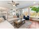 Bright living room with hardwood floors, built-in shelving, and large windows offering natural light at 620 Briar Patch Ter, Waxhaw, NC 28173