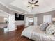 Main bedroom with en suite bathroom access, hardwood floors and tray ceilings at 620 Briar Patch Ter, Waxhaw, NC 28173