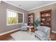 Sitting room featuring comfortable seating, natural light and wooden shelves at 620 Briar Patch Ter, Waxhaw, NC 28173