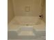 This bathroom features a neutral toned built-in bathtub with tiled walls at 6271 Sherwood Ln, Denver, NC 28037