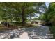 Single story home with a long gravel drive and lush mature trees at 6271 Sherwood Ln, Denver, NC 28037