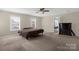 Spacious carpeted main bedroom featuring ceiling fan and natural light from multiple windows at 649 Shellbark Dr, Concord, NC 28025