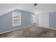 Bright bedroom with two windows, neutral carpet, and double door closet at 649 Shellbark Dr, Concord, NC 28025