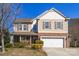 Charming two-story home featuring a brick facade, attached two-car garage, and manicured front yard at 649 Shellbark Dr, Concord, NC 28025