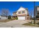 Two-story home with a front-facing garage, brick accents, and manicured landscaping at 649 Shellbark Dr, Concord, NC 28025