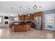 Open kitchen features a large island with granite countertop, stainless steel appliances and pendant lighting at 649 Shellbark Dr, Concord, NC 28025