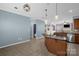 Open kitchen features a large island with granite countertop and pendant lighting. Space for dining table at 649 Shellbark Dr, Concord, NC 28025