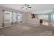 Spacious living room with carpet floors open to kitchen with lots of natural light from large windows at 649 Shellbark Dr, Concord, NC 28025