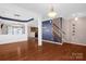 Open-concept living space with hardwood floors, decorative columns, and a view of the kitchen at 649 Shellbark Dr, Concord, NC 28025