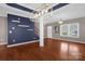 Bright living room with hardwood floors, modern lighting, and a view of the staircase at 649 Shellbark Dr, Concord, NC 28025