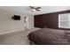 Large carpeted main bedroom features a ceiling fan, and natural light from a window at 649 Shellbark Dr, Concord, NC 28025