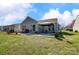 Backyard showing a well-manicured lawn, concrete patio, and outdoor living space at 7918 Travers Run Dr, Charlotte, NC 28215