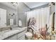 A bathroom featuring a granite countertop, mirror, sink, toilet, and shower with a curtain at 7918 Travers Run Dr, Charlotte, NC 28215