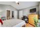 A bedroom featuring a bed, TV, and a view of the ensuite bathroom at 7918 Travers Run Dr, Charlotte, NC 28215