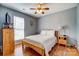 A bedroom featuring a bed, a ceiling fan, and wood floors at 7918 Travers Run Dr, Charlotte, NC 28215