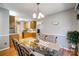 An eat-in dining room featuring a glass table connected to the kitchen with wooden cabinets at 7918 Travers Run Dr, Charlotte, NC 28215