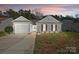 Charming home featuring a manicured lawn, covered entryway, and attached one car garage at 7918 Travers Run Dr, Charlotte, NC 28215