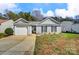 Charming home featuring a manicured lawn, covered entryway, and attached one car garage at 7918 Travers Run Dr, Charlotte, NC 28215