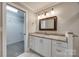 Bathroom featuring vanity with granite countertop, decorative mirror, and walk-in closet with shelves at 801 Sandifer Rd, York, SC 29745