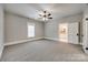 Spacious bedroom with a ceiling fan, large window, and a doorway to the bright bathroom at 801 Sandifer Rd, York, SC 29745