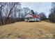 Charming home with red roof, and inviting porch, nestled on a spacious lot with surrounding trees at 801 Sandifer Rd, York, SC 29745