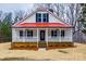 Inviting home featuring a red roof, white siding, and charming front porch at 801 Sandifer Rd, York, SC 29745