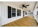 Expansive porch showcasing wood floors, white columns, and multiple ceiling fans at 801 Sandifer Rd, York, SC 29745