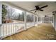 Spacious porch with wooden floors, white railings, and a view of the wooded surroundings at 801 Sandifer Rd, York, SC 29745