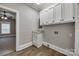 Functional laundry room with built-in storage, granite countertops, and hardwood floors at 801 Sandifer Rd, York, SC 29745