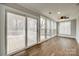 Sunroom with wooden floors, many windows and sliding doors to the porch at 801 Sandifer Rd, York, SC 29745