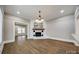 Open-concept living room featuring hardwood floors and a charming brick fireplace at 801 Sandifer Rd, York, SC 29745