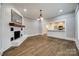 Open-concept living room with white-painted brick fireplace and seamless flow to the kitchen at 801 Sandifer Rd, York, SC 29745