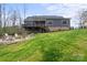 View of backyard with lush lawn, fire pit, and deck area at 820 Bellegray Rd, Clover, SC 29710