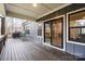 View of the covered deck with black trim windows and sliding glass doors at 820 Bellegray Rd, Clover, SC 29710