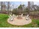 Outdoor fire pit area with stone pavers and chairs in fenced backyard at 820 Bellegray Rd, Clover, SC 29710