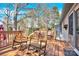 Spacious back deck with multiple rocking chairs and views of the mature trees, perfect for outdoor gatherings at 8210 Mattingridge Dr, Charlotte, NC 28270